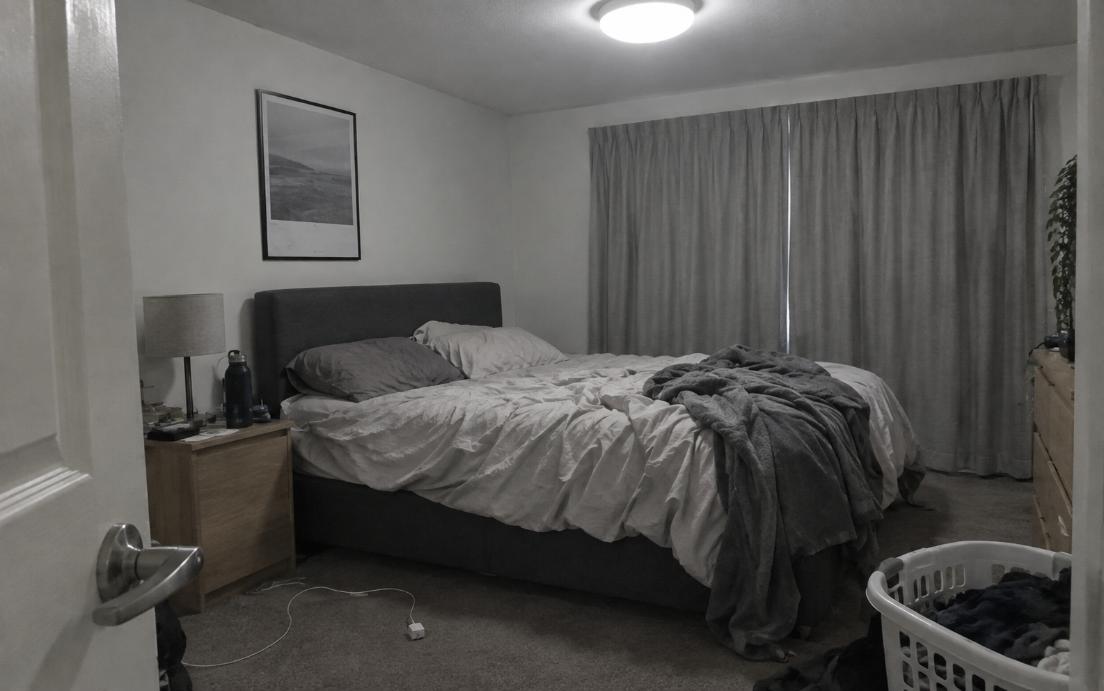 Bedroom before restyling, dim and cluttered